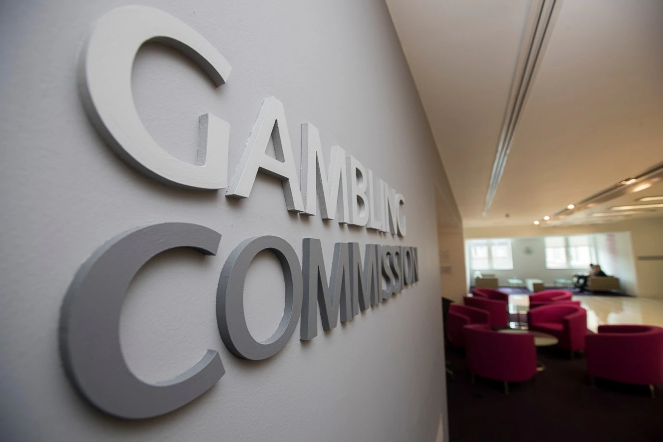 Gambling Commission chair announcement - UKGC office with logo on wall and red chairs