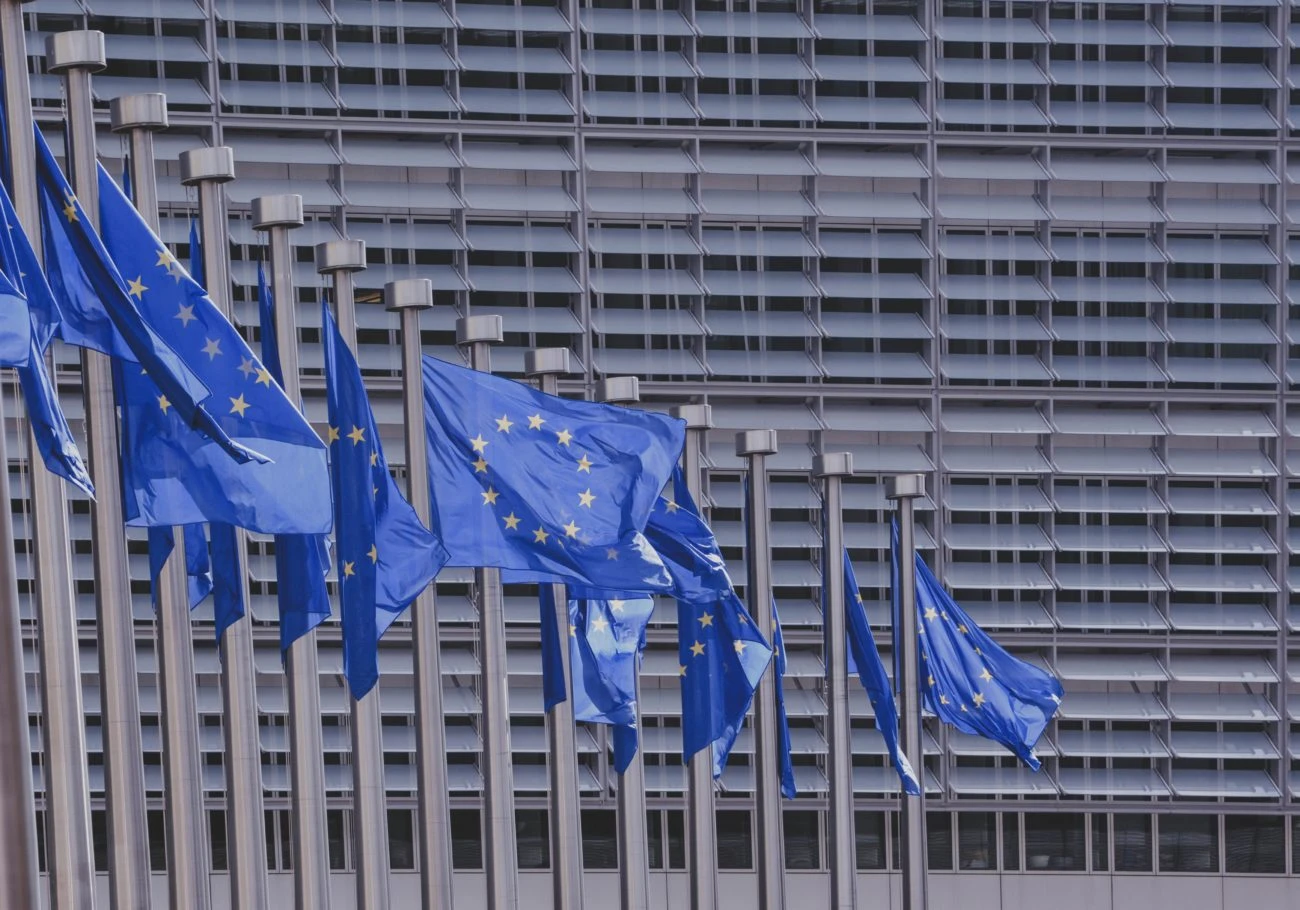 EU flags waving against a skyscraper as MEPs debate gambling advertising ban proposals