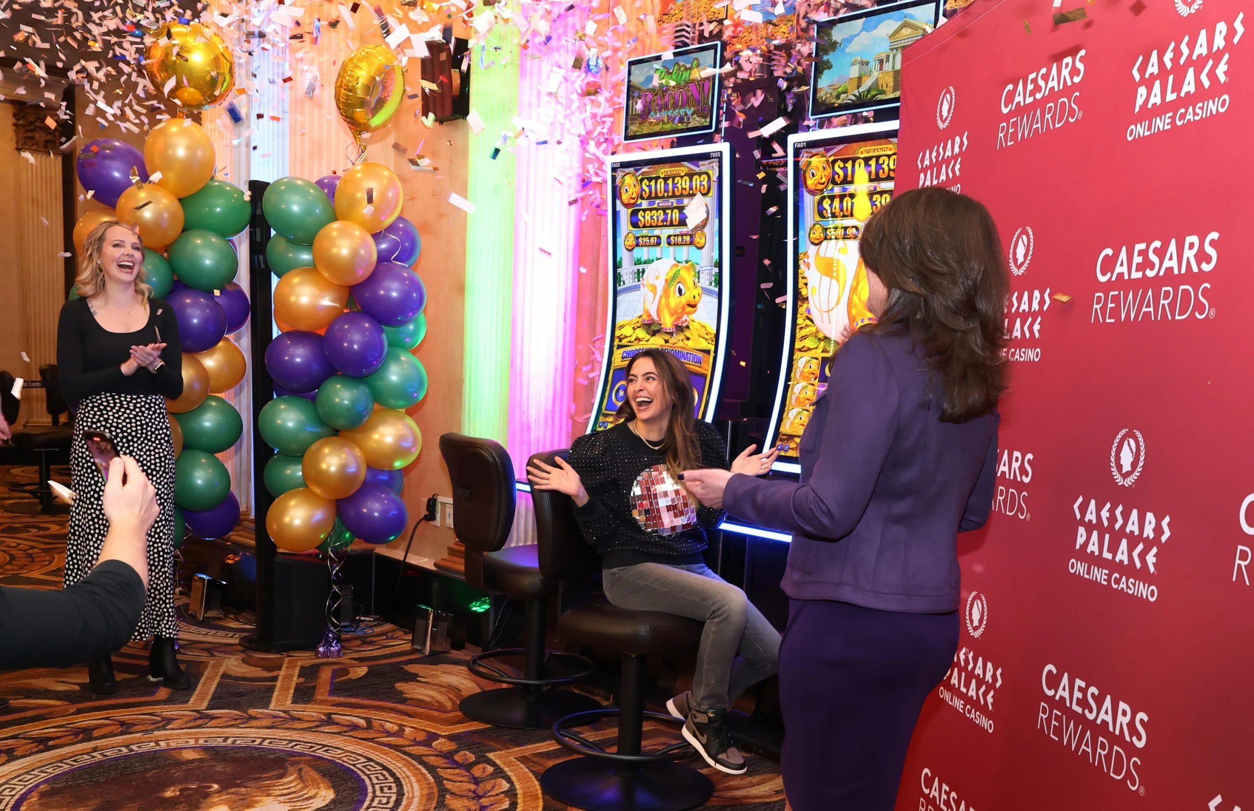 Two people attending the launch of slot game Rakin Bacon Odyssey at Caesars Atlantic City