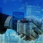 handshake with cityscape superimposed