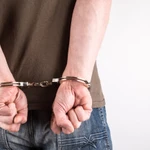 man handcuffs behind back