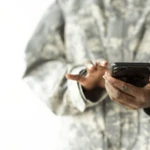 female soldier on phone as automated service issued for military personnel