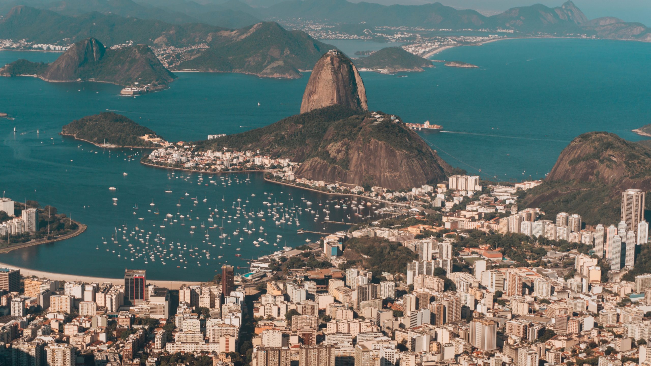 A bird’s-eye view of Rio de Janeiro, bathed in sunlight, with the city nestled between the ocean and surrounding hills in Brazil, which has recently legalised the online gambling market
