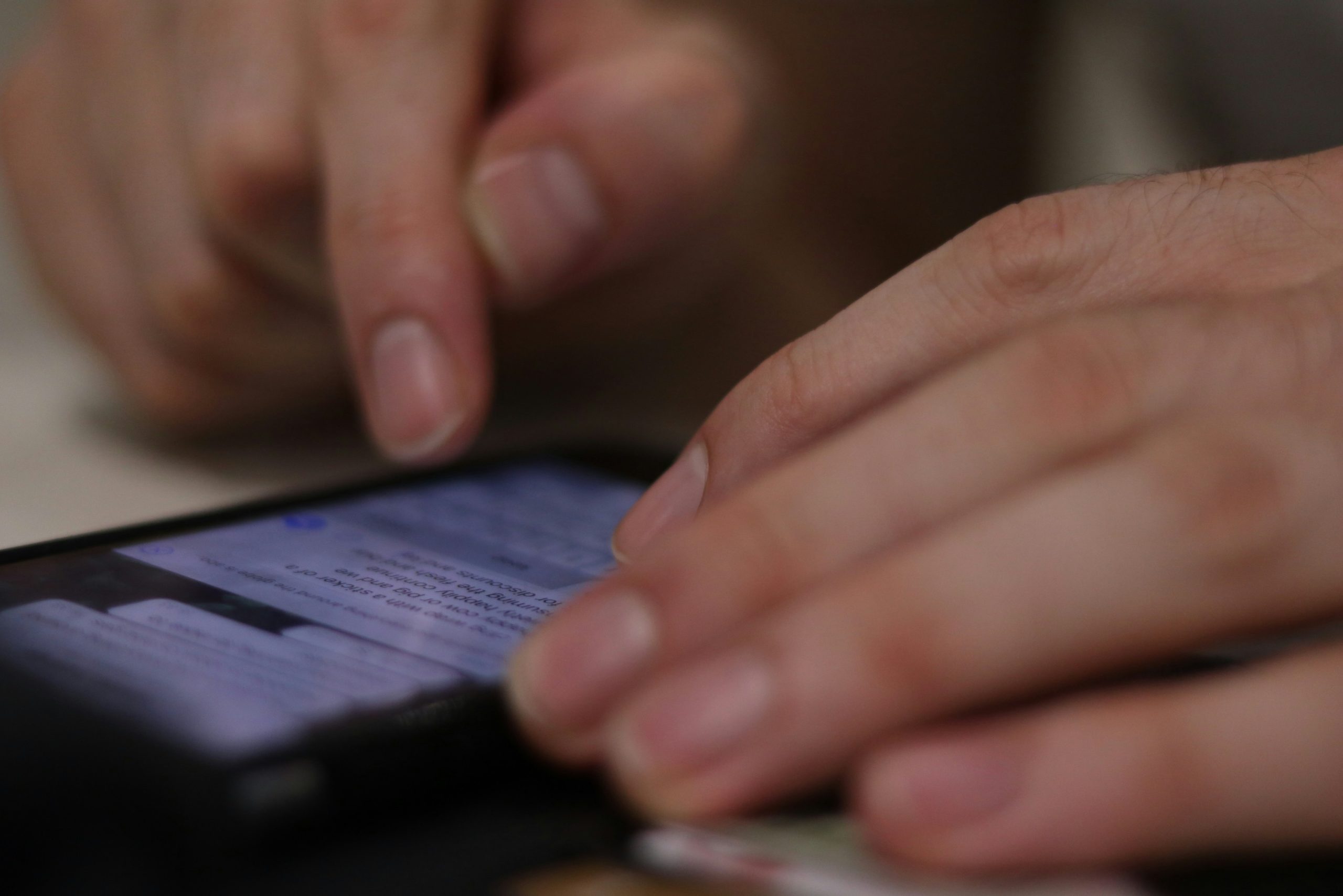 person typing on mobile phone