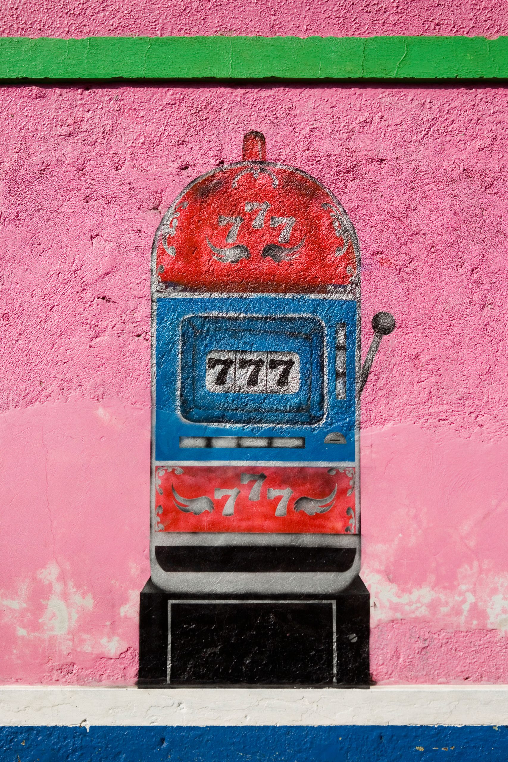 Painted mural of a slot machine on a wall somewhere in Latin America